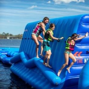 Photo of family playing on inflatable on lake at Tapnell Farm Park, Isle of Wight.
